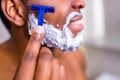 hispanic man put on foam on beard perfume lotion or skin care cream for sensitive skin