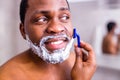 hispanic man put on foam on beard perfume lotion or skin care cream for sensitive skin