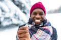 hispanic man in red hat with snowflake on face having fun and feeling christmas mood in park