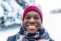 hispanic man in red hat with snowflake on face having fun and feeling christmas mood in park