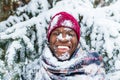 hispanic man in red hat with snowflake on face having fun and feeling christmas mood in park