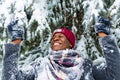 hispanic man in red hat with snowflake on face having fun and feeling christmas mood in park