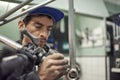 Hispanic man removing paint residue from a bike frame at his workshop Royalty Free Stock Photo