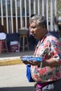 Hispanic man sells outside candy
