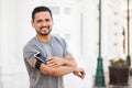 Hispanic man with a smartphone in an armband Royalty Free Stock Photo