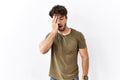 Hispanic man standing over isolated white background yawning tired covering half face, eye and mouth with hand Royalty Free Stock Photo