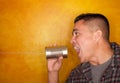 Hispanic man with tin can telephone Royalty Free Stock Photo