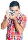 Hispanic man using a vintage looking compact camera Royalty Free Stock Photo