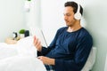 Hispanic man watching a tv series on his tablet Royalty Free Stock Photo