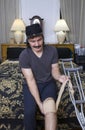Hispanic man wrapping bandage over knee joint