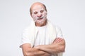 Hispanic mature man in a cosmetic mask skin care