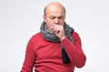 Hispanic mature man having flu and cough. Royalty Free Stock Photo