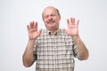 Hispanic mature man showing refusal gesture. It is not for me, leave me in piece Royalty Free Stock Photo