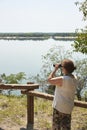 Latin woman looking through binoculars from a viewpoint, El Palmar National Park Royalty Free Stock Photo