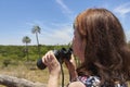 Hispanic mature woman using binoculars, El Palmar National Park, Argentina Royalty Free Stock Photo
