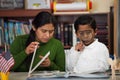 Hispanic Mom and Boy in Home-school Setting Studying Rocks Royalty Free Stock Photo