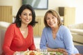 Hispanic Mother With Adult Daughter Enjoying Meal At Home Royalty Free Stock Photo