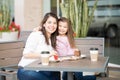Hispanic mother and daughter in a cafe Royalty Free Stock Photo