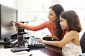 Hispanic mother and daughter using computer at home Royalty Free Stock Photo