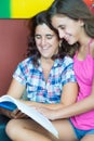 Hispanic mother and her daughter reading a book Royalty Free Stock Photo