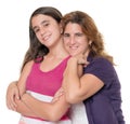 Hispanic mother hugs her teenage daughter isolated on white