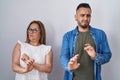 Hispanic mother and son standing together disgusted expression, displeased and fearful doing disgust face because aversion Royalty Free Stock Photo