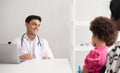 Hispanic physician meeting and diagnosis mixed-race afro children with her African American mother at a hospital. The doctor Royalty Free Stock Photo