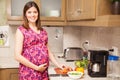 Hispanic pregnant woman making a salad Royalty Free Stock Photo