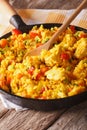 Hispanic rice with chicken and vegetables close-up in a pan. vertical Royalty Free Stock Photo