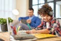 Hispanic school boy wearing headphones, preparing homework while sitting at the desk at home. Father and son spending Royalty Free Stock Photo