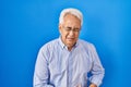 Hispanic senior man wearing glasses with hand on stomach because indigestion, painful illness feeling unwell Royalty Free Stock Photo