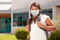 Hispanic Student Girl Wearing Face Mask with Backpack on School Campus Royalty Free Stock Photo