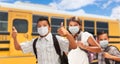 Three Hispanic Students Near School Bus Wearing Face Masks Royalty Free Stock Photo
