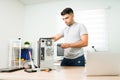 Hispanic technician checking the pc hardware