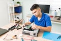 Hispanic technician installing a hard drive on a CPU