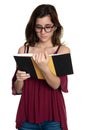 Hispanic teenage girl with glasses reading a book - On a white background Royalty Free Stock Photo