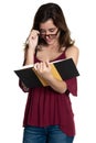 Hispanic teenage girl with glasses reading a book - On a white background Royalty Free Stock Photo