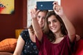 Hispanic teenage girl and her mother taking a selfie at home Royalty Free Stock Photo