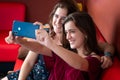 Hispanic teenage girl and her mother taking a selfie at home Royalty Free Stock Photo