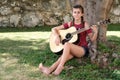 Hispanic teenage girl playing an acoustic guitar Royalty Free Stock Photo