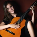 Hispanic teenage girl playing an acoustic guitar Royalty Free Stock Photo