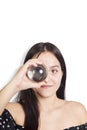 Hispanic teenage girl playing with crystal ball on white background. Mysticism concept Royalty Free Stock Photo