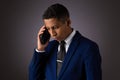 Hispanic Teenager Dressed Well Dressed in Suit, and Using Cellphone, Smartphone