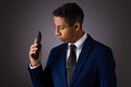 Hispanic Teenager Dressed Well Dressed in Suit, and Using Cellphone, Smartphone