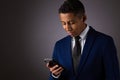 Hispanic Teenager Dressed Well Dressed in Suit, and Using Cellphone, Smartphone