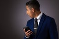 Hispanic Teenager Dressed Well Dressed in Suit, and Using Cellphone, Smartphone