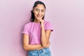 Hispanic teenager girl with dental braces wearing casual clothes smiling looking confident at the camera with crossed arms and Royalty Free Stock Photo