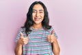 Hispanic teenager girl with dental braces wearing casual clothes success sign doing positive gesture with hand, thumbs up smiling Royalty Free Stock Photo