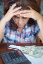 Hispanic woman counting money at home to pay the bills Royalty Free Stock Photo