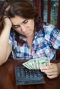 Hispanic woman counting money at home to pay the bills Royalty Free Stock Photo